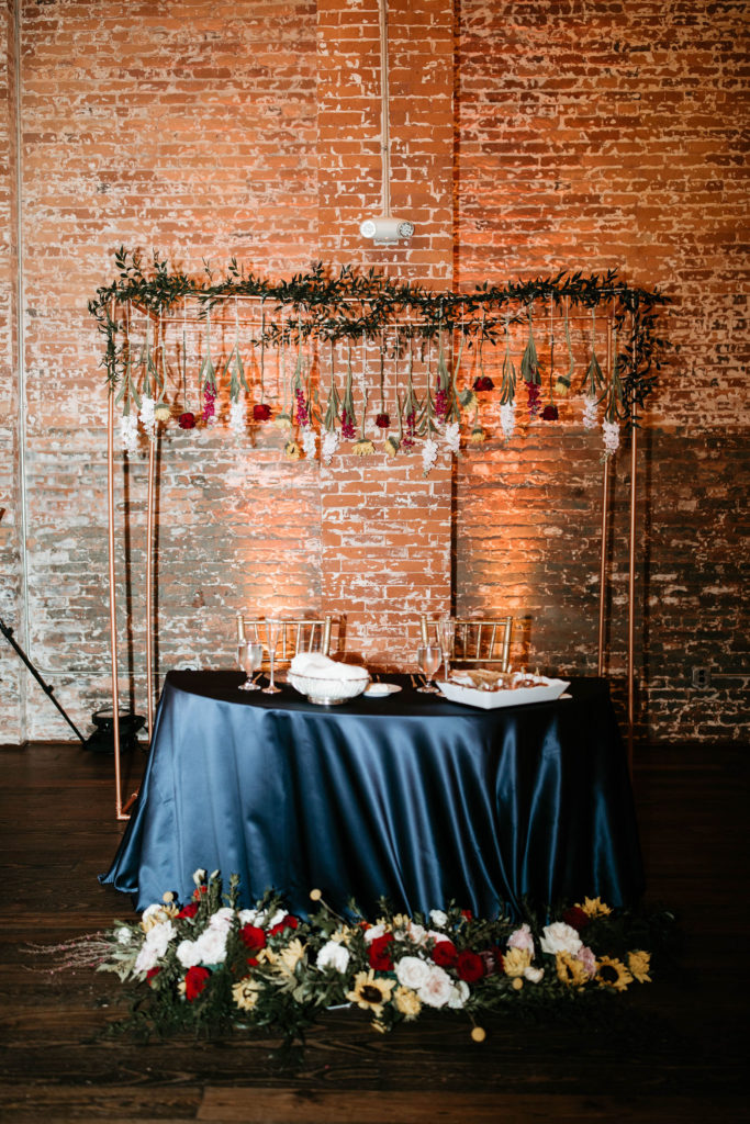 Sweetheart table with sunflowers at wedding