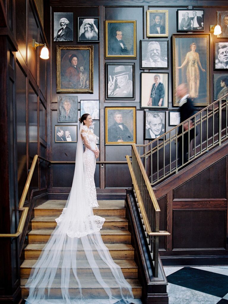 Bride on atrium staircase during Oxford Exchange wedding